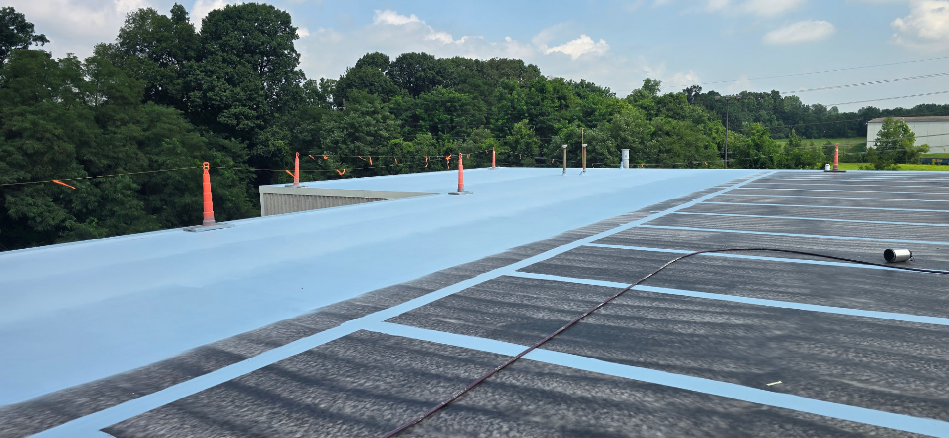 Commercial roof restoration in progress with seams reinforced before full coating application near Bowling Green, KY